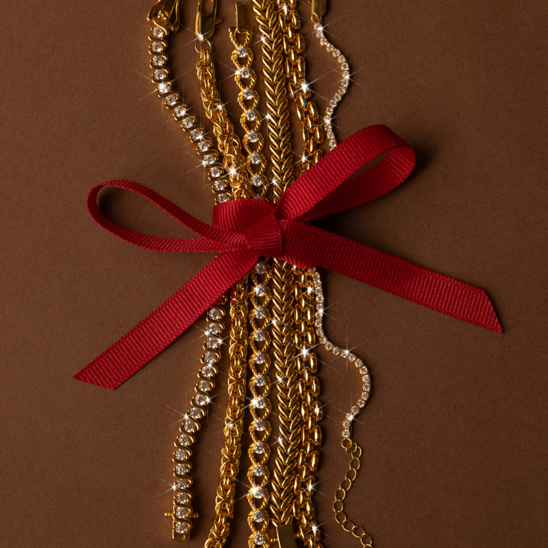 Gold bracelets on a red ribbon