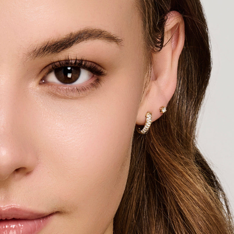 Model wearing drop earrings